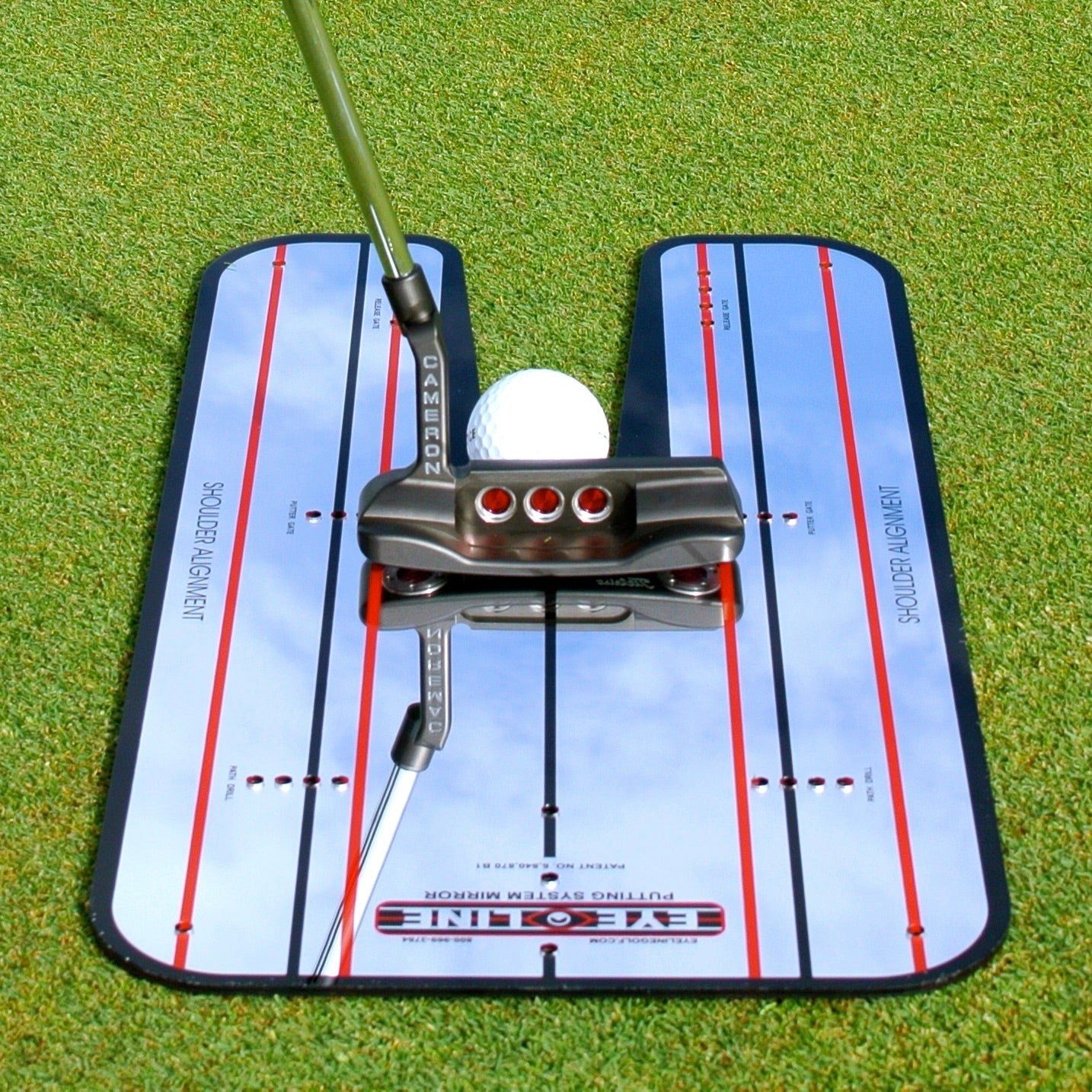 A putter and golf ball positioned on a large EyeLine putting mirror with red and black alignment lines.